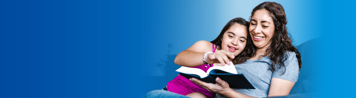 Smiling mother and daughter reading a book