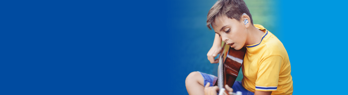 A young boy with hearing aids