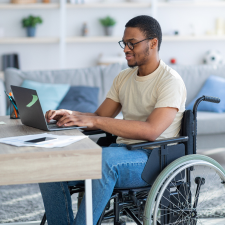 young man with Down syndrome working behind a cash register at a grocery store