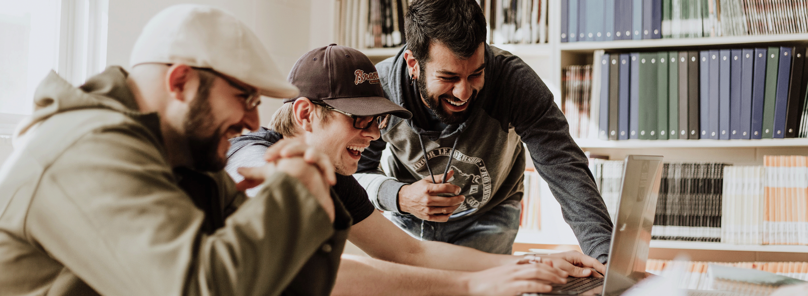 A group of men looking at a computer