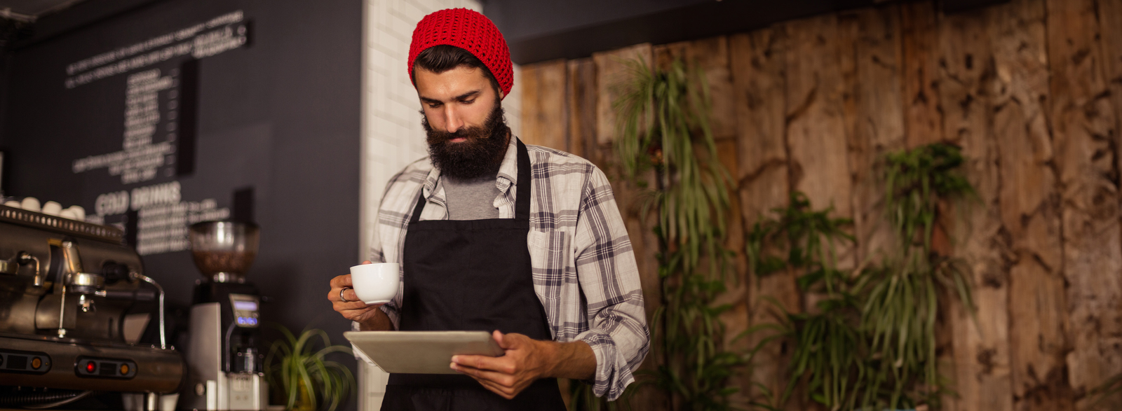 Barista behind a counter holding a cup