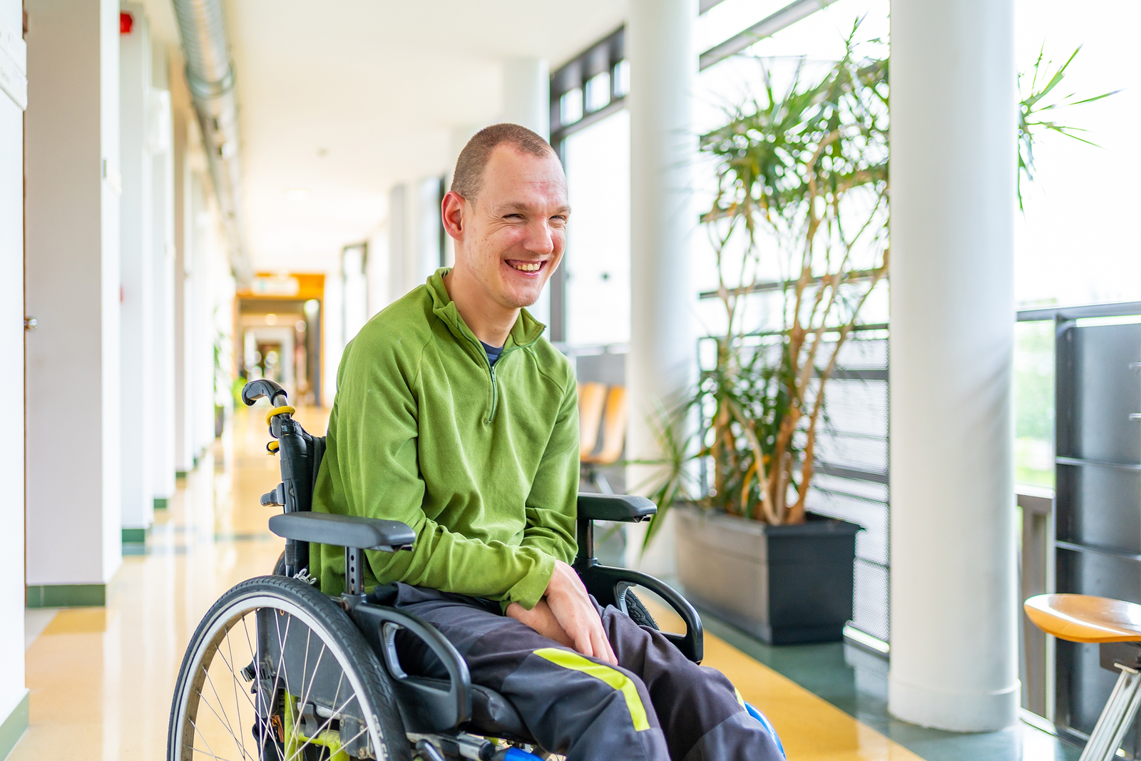 a young man sitting in a wheelchair